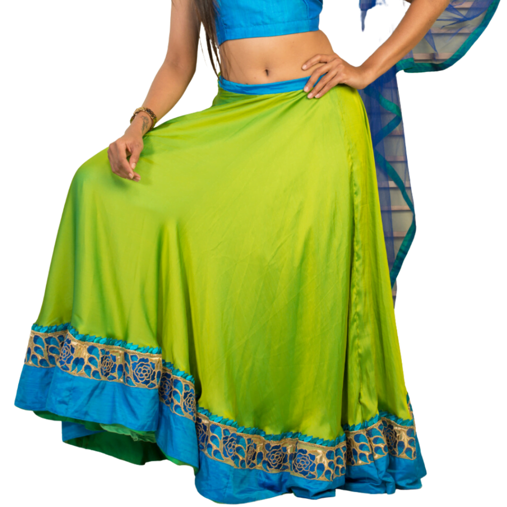 a woman wearing green and blue indian lehenga
