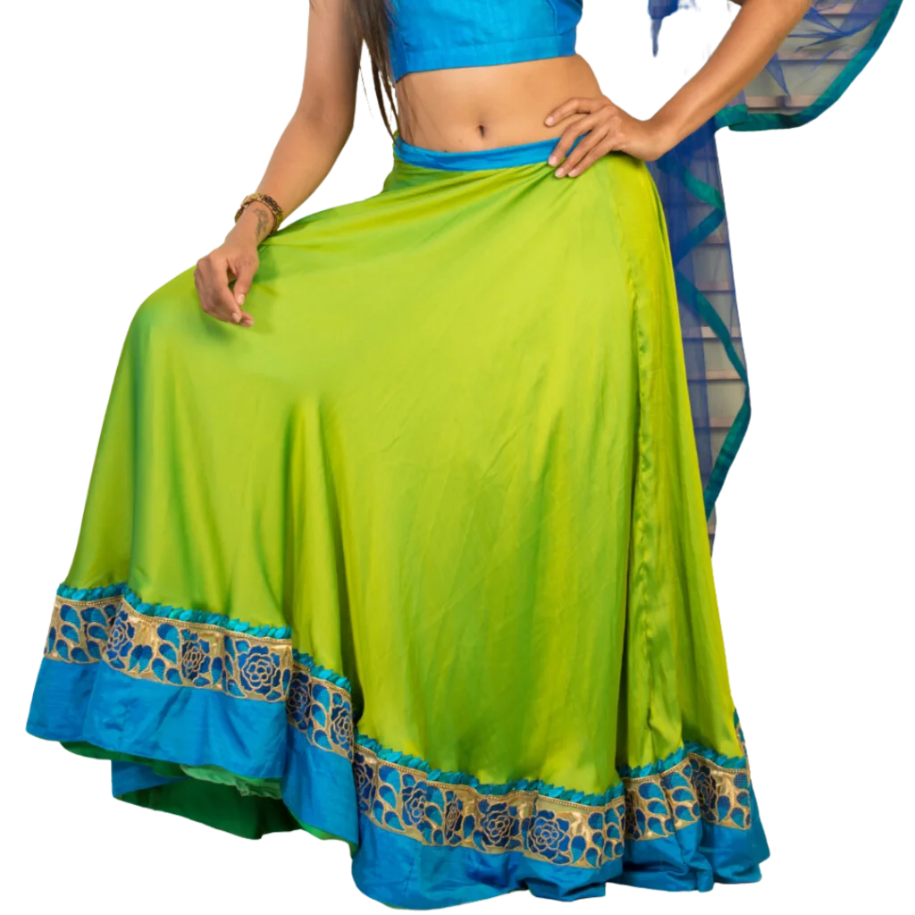 a woman wearing green and blue indian lehenga